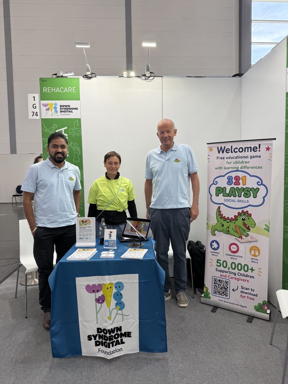 Down Syndrome Digital team and 321Playsy display at the REHACARE 2026 exhibitor stand.