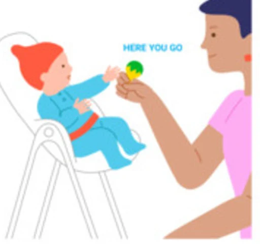 A baby reaches toward a toy held by a caregiver.