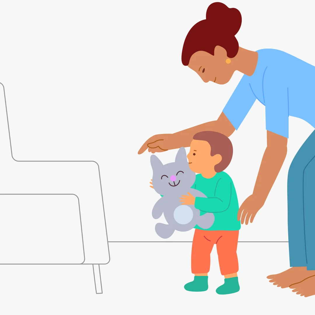Illustration for “First Steps with a Moving Support”, step 2: Help the child hug the toy with both arms, holding it in front.