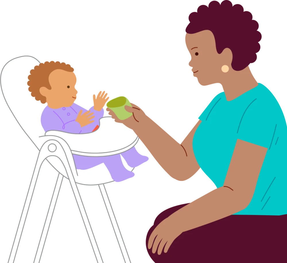 A caregiver shows a small cup to a baby in supported upright seating.
