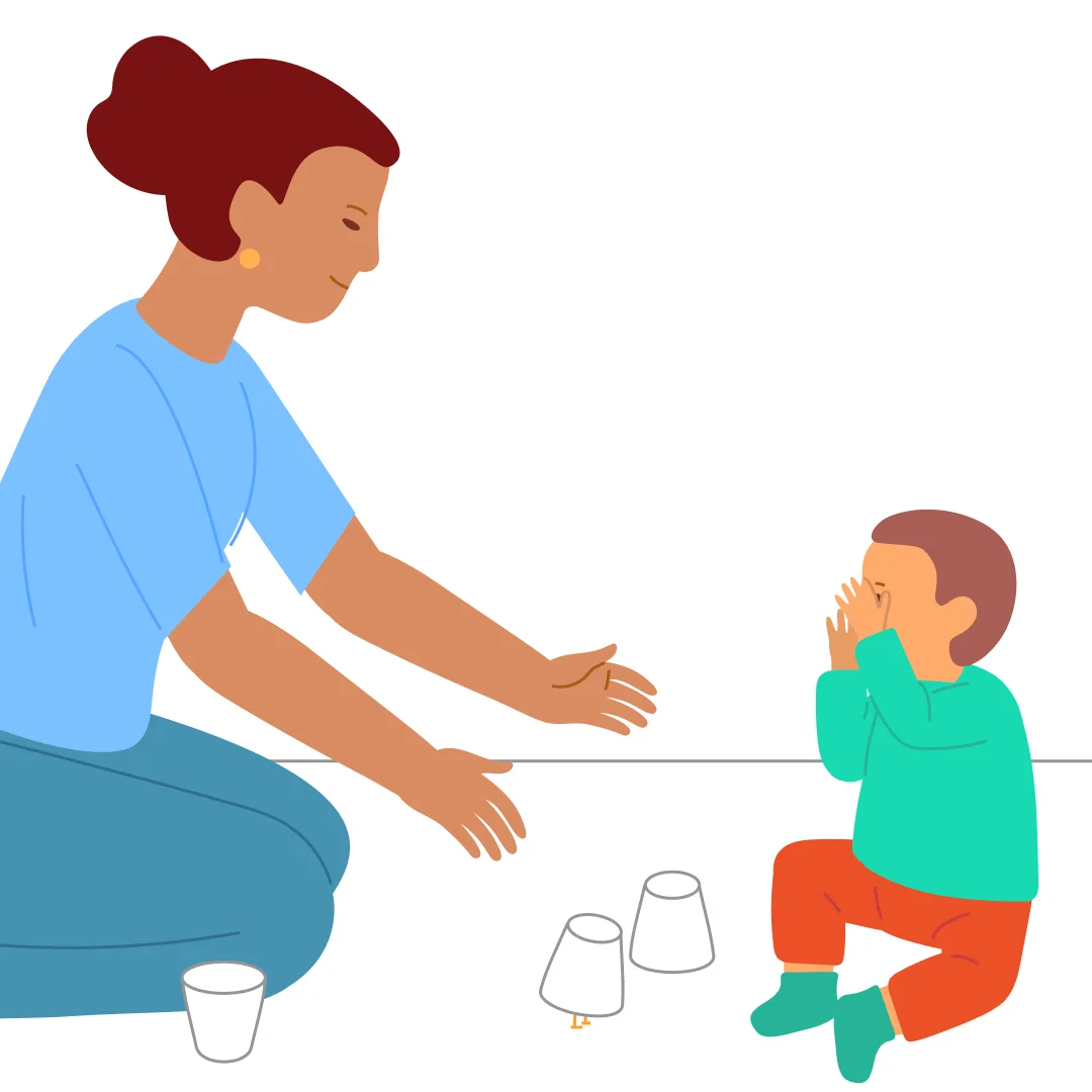 Illustration for “Hide and Seek in Cups”, step 4: Say: “Close your eyes, the chick will hide.” Hide it under one of two cups and invite the child to look: “Where’s the chick?” Help them lift each cup.