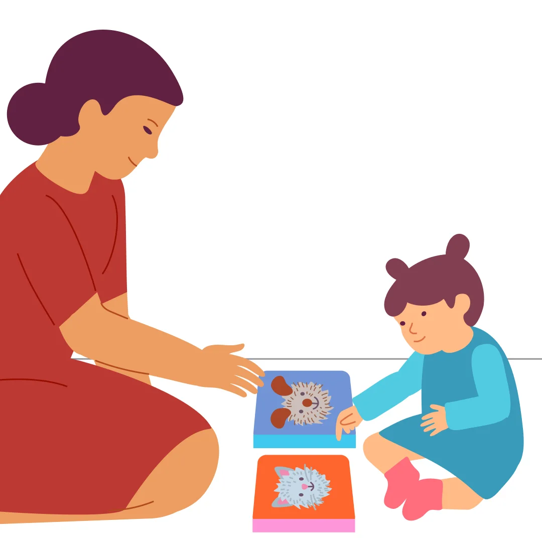 Illustration for “Read and Point!”, step 1: Place two books in front of your child.