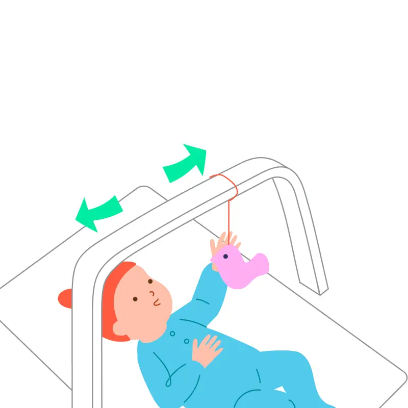 A baby watches a toy move gently from side to side on a play gym.